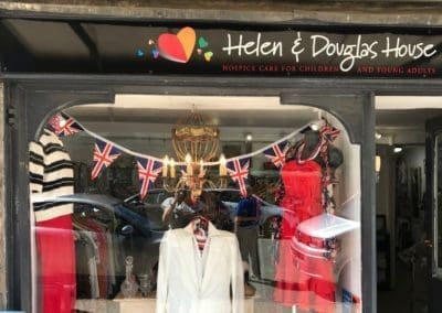 Burford shop window with bunting and Helen & Douglas logo