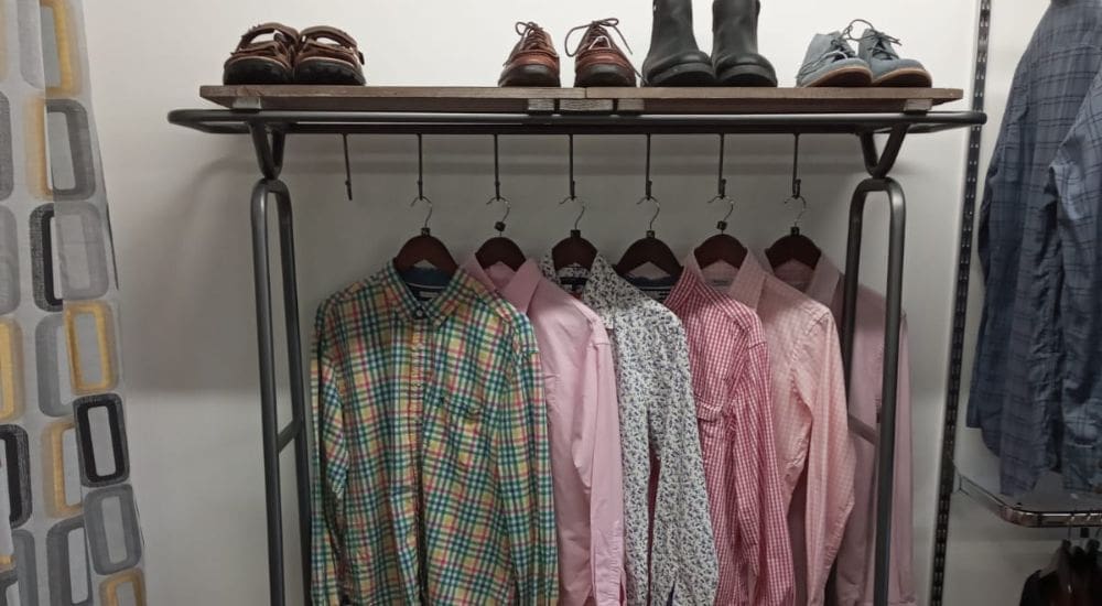 A rack of mens chequered shirts and shoes