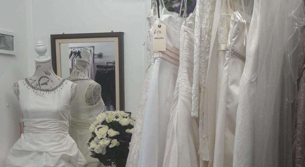 picture of a rack of wedding dresses
