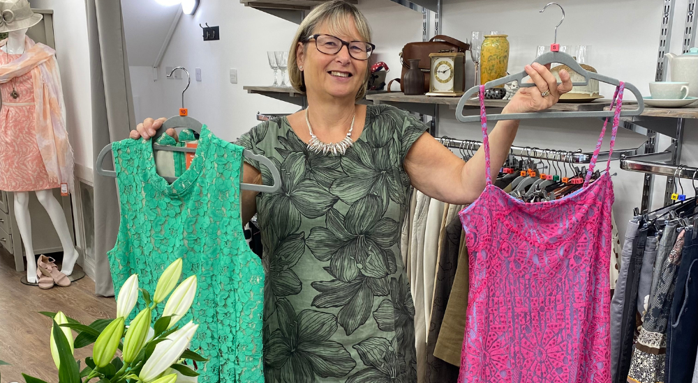 Marlow shop staff member with green and pink dresses