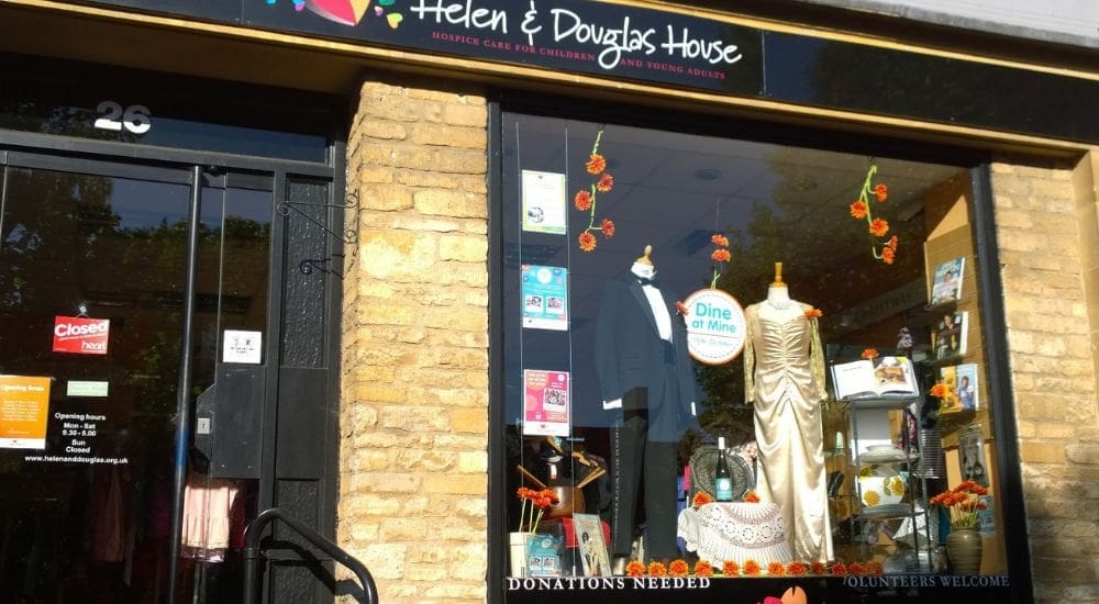 Witney shop window from front with dress and suit_1000x550