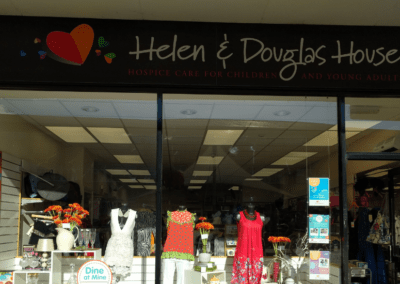 Woodley shop front with Helen & Douglas House logo