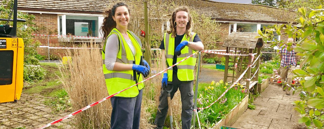 Two volunteers in the garden