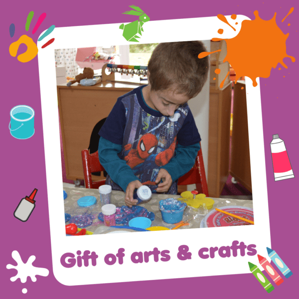 'Gift of arts and crafts' graphic showing a boy making crafts, part of Charity Gift Cards