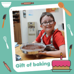 'Gift of baking' graphic showing a smiley boy, part of Charity Gift Cards
