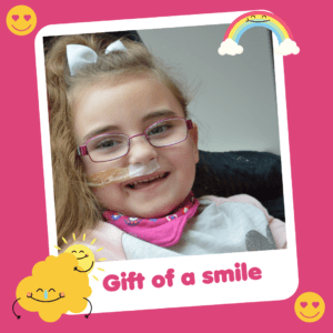'Gift of a smile' graphic showing a smiley girl, part of Charity Gift Cards
