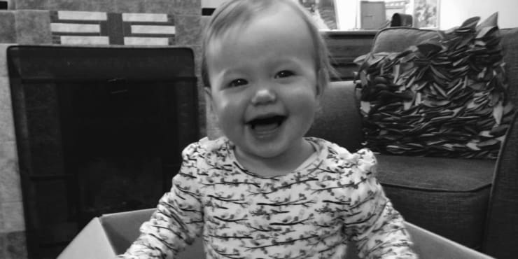 Black and white image of little girl smiling