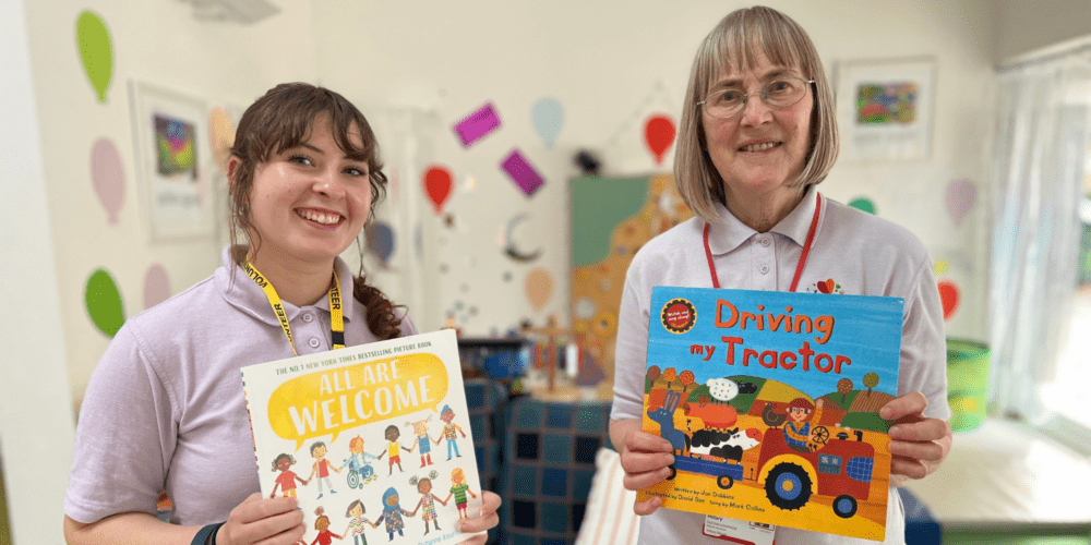 Woman and girl holding childrens books at the hospice